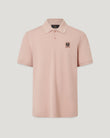 Close up of dusk pink Belstaff polo showing textured piqué fabric collar and chest patch.