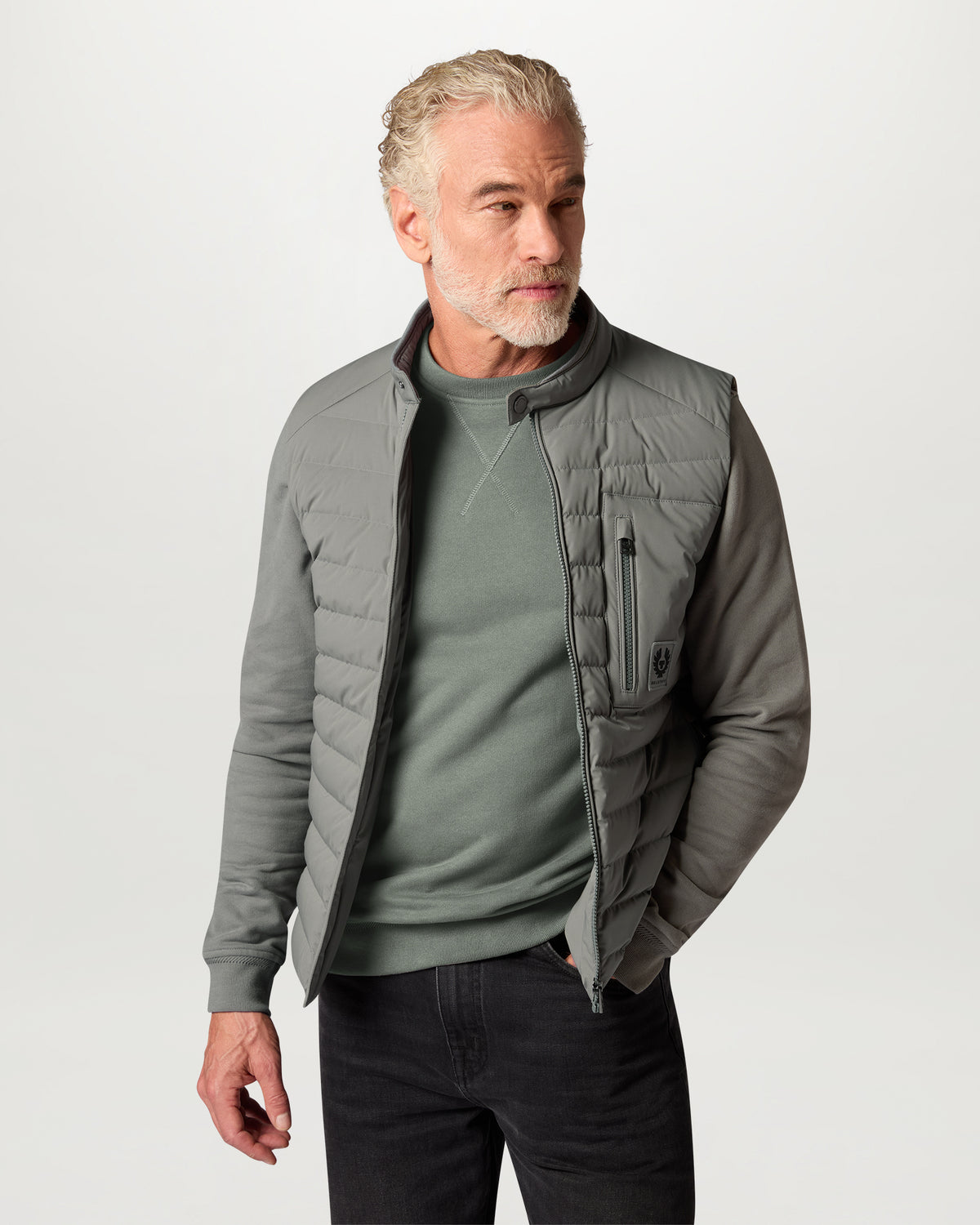 Man wearing a light Atlantic Grey Belstaff sweatshirt with chest Phoenix emblem