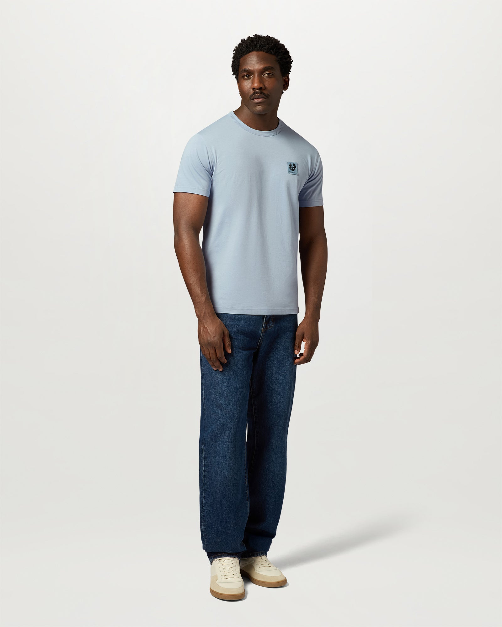 Male model wearing a Mist Blue Belstaff crew-neck T-shirt with logo patch on the chest