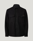 Man wearing black Castle overshirt with two chest pockets and a button front
