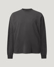 Close up of iron colored long sleeve shirt with a subtle embossed emblem on the chest