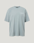 Close-up of a light blue BE STAFF T shirt with a small logo on the chest