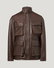 Male model wearing a dark maple brown leather Competitor jacket with four front pockets and snap details