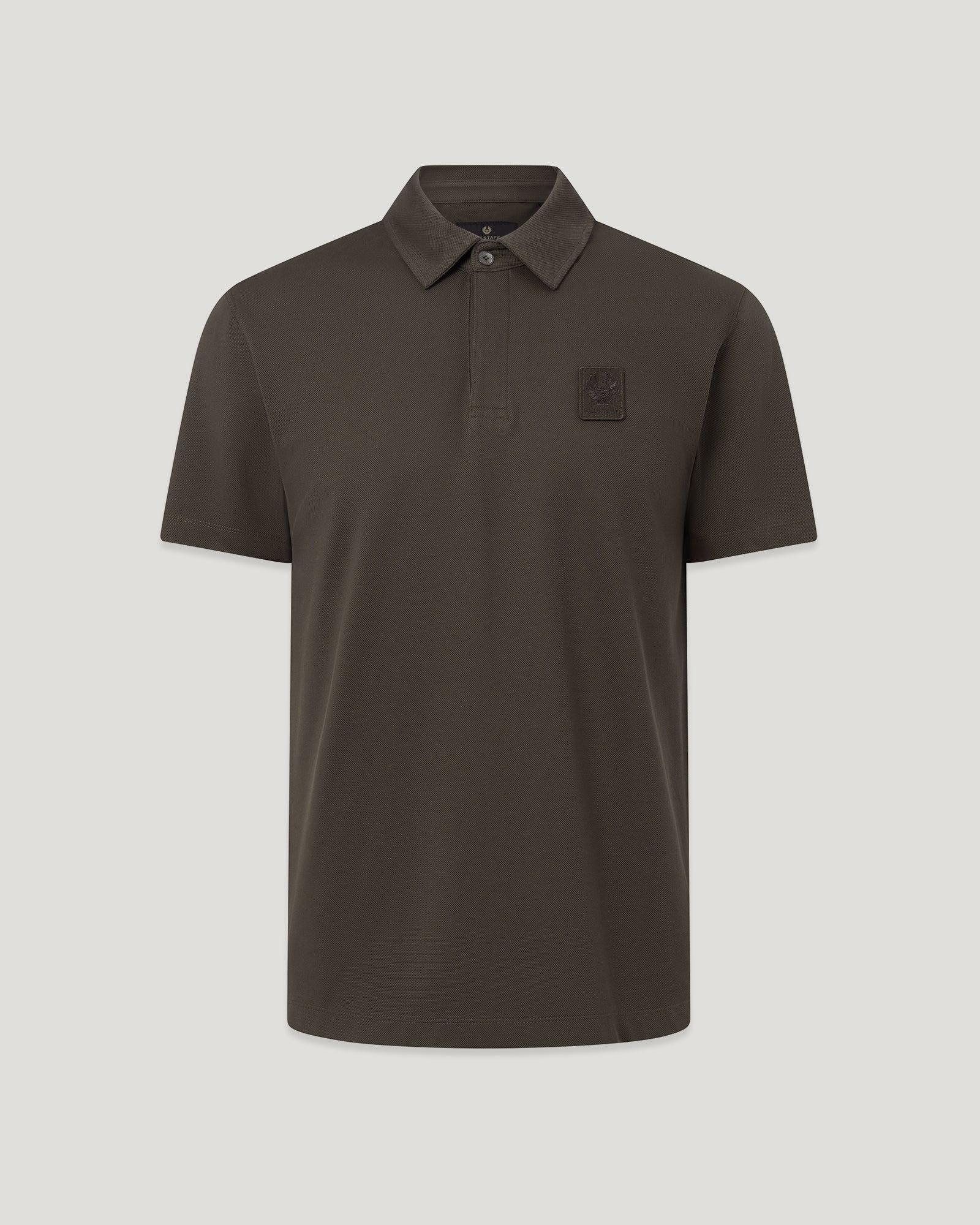 Close up of Curator Polo in Army Olive with collar and chest embroidery patch