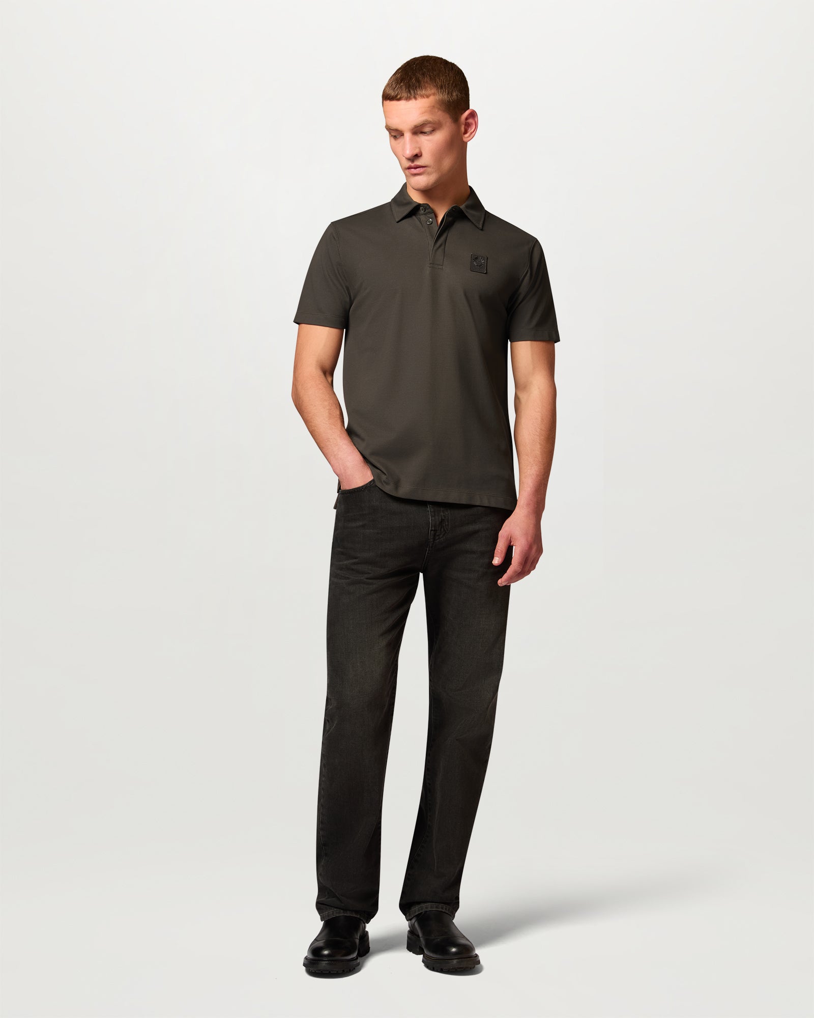 Man wearing Army Olive Curator polo in Supima cotton pique with a small chest logo