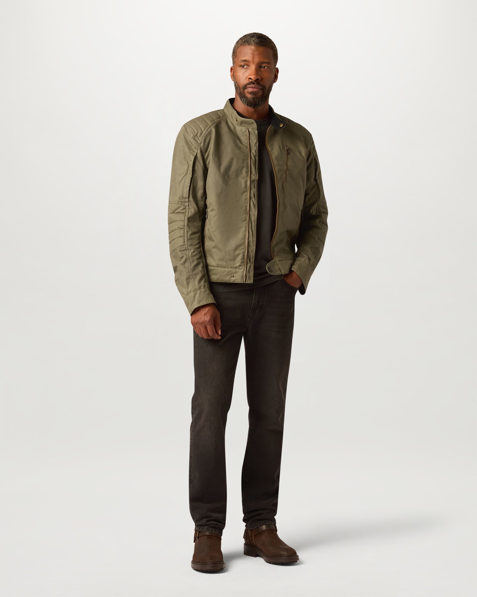 Man wearing olive Belstaff Humber Motorcycle Jacket with zip front and stand collar.