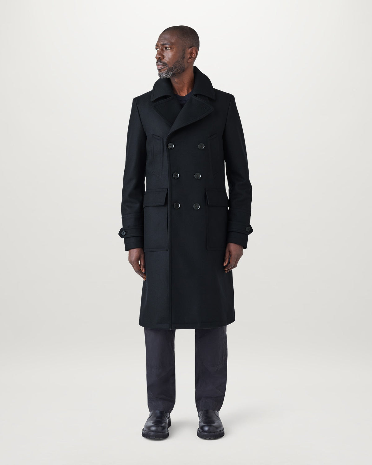 Male model wearing a navy Milford double-breasted wool coat with wide lapels