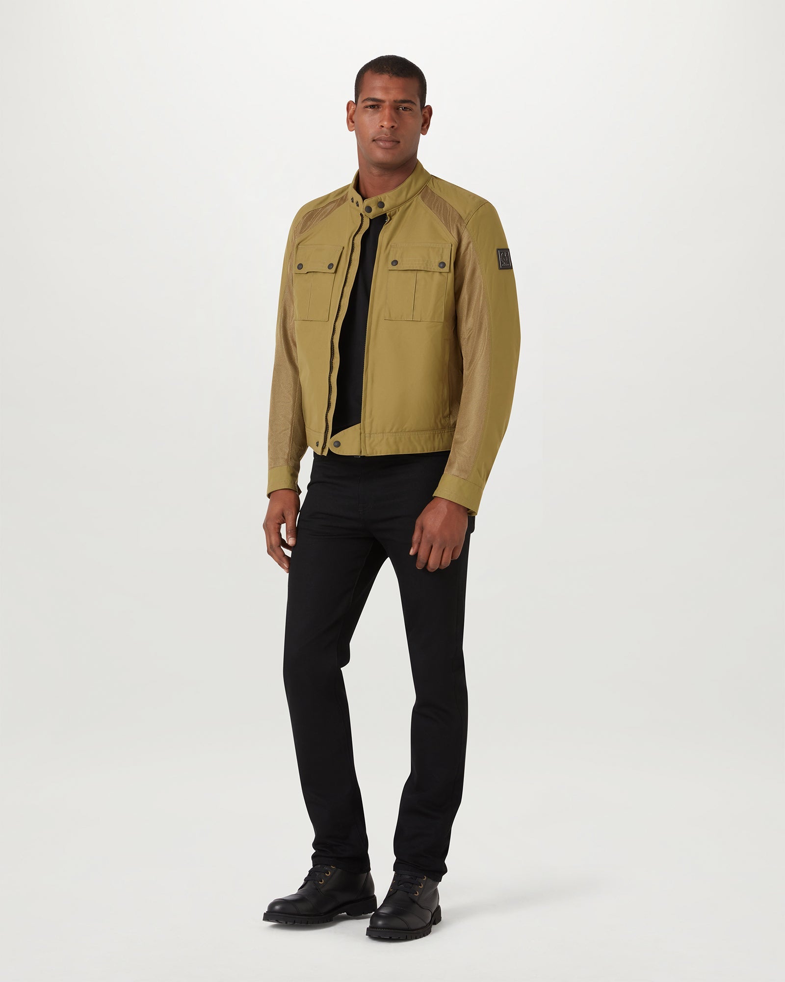Model wearing olive Temple Motorcycle Jacket with two chest pockets and a slim fit silhouette