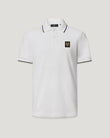 Close-up of white Tipped Polo showing black trim on collar and a chest emblem
