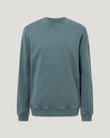 Front view of a male model wearing the Valley garment-dye Sweatshirt in Petrol with a relaxed fit