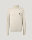 Close-up of pale stone Watch Roll Neck Jumper highlighting ribbed collar and chest patch